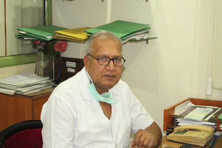 Senior doctor seated at his desk in the DLF City clinic