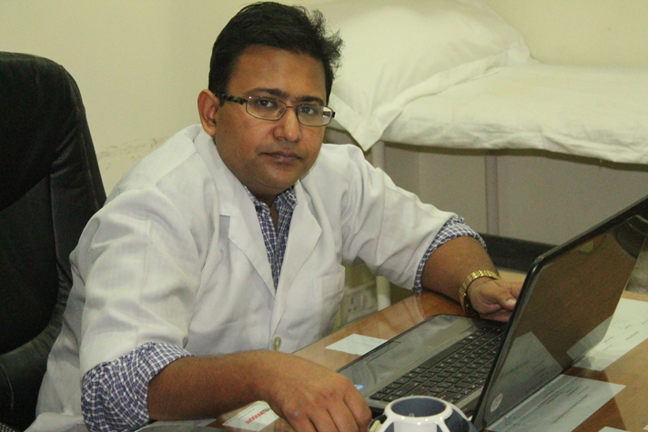 Doctor working on a laptop at his desk