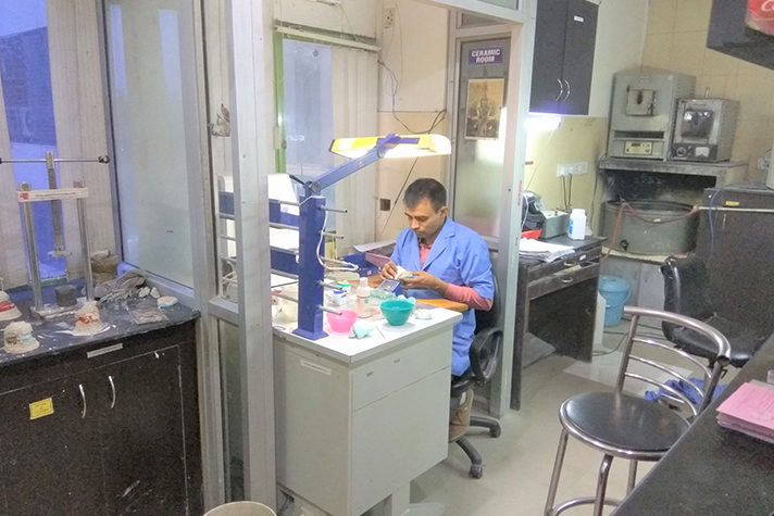 Dental technician working at the laboratory bench