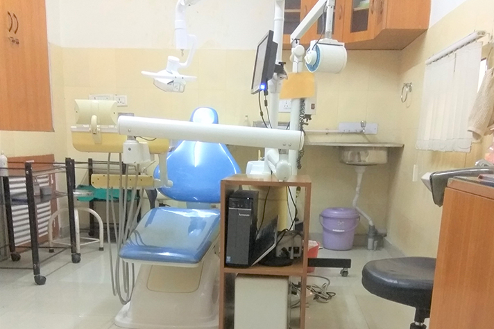 Blue dental chair in a treatment room