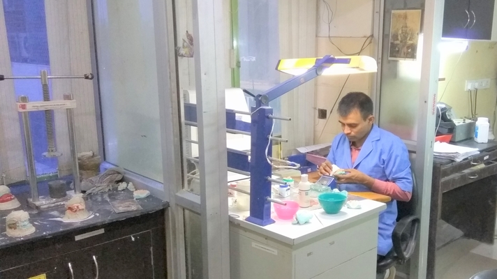 Dental technician working at a bench in the Dental Craft laboratory