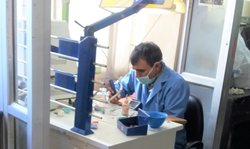 Technician fabricating crowns and bridges at the laboratory bench