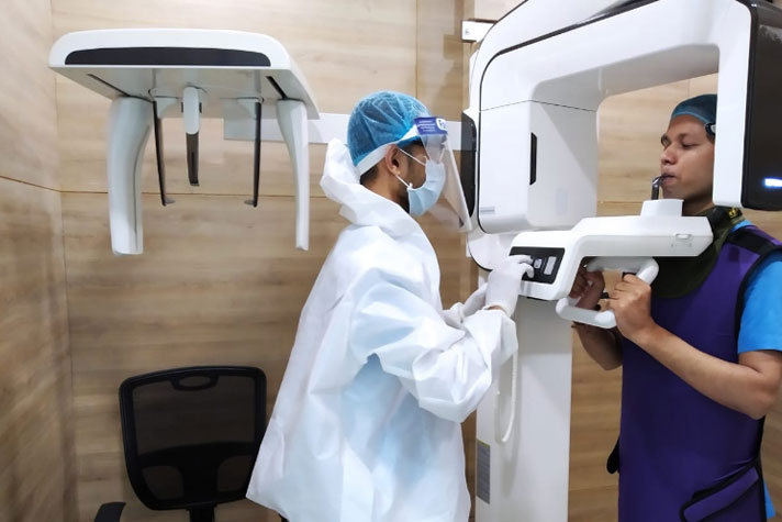 Staff member operating the X-ray machine